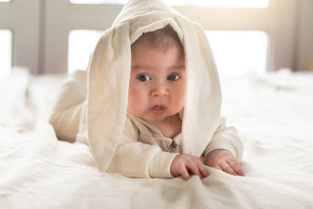 istock Having fun on Easter day. Baby boy wearing bunny costume with ears smiling. 1132554372