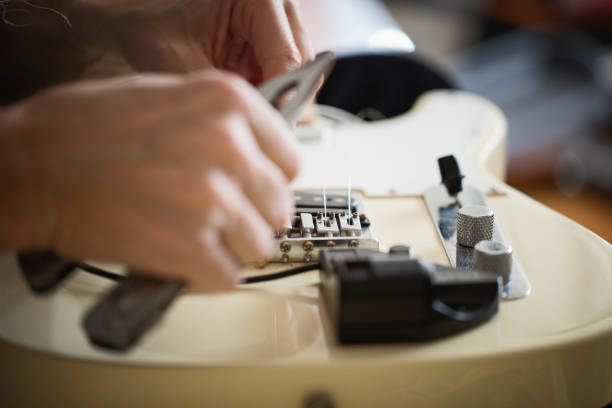 istock Telecaster type electric guitar, seting up strings, close-up 1132555814