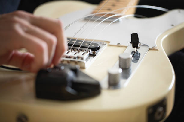 istock Telecaster type electric guitar, seting up strings, close-up 1132556175