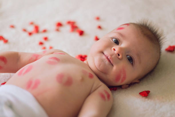 Cute baby boy covered with lipstick kisses