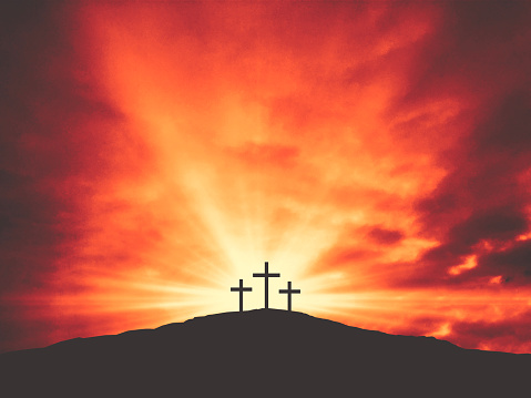 Three Christian Good Friday Crosses Silhouette on Hill of Calvary with Sun and Clouds in Sky Background - Crucifixion of Jesus Christ