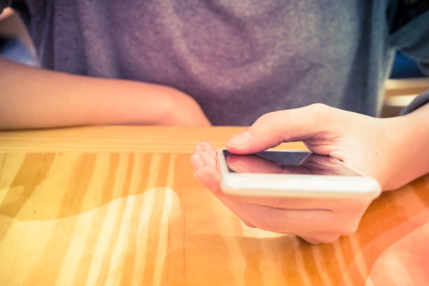 istock Midsection Of Woman Using Phone On Table 1132557857