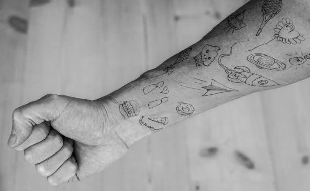 Close up of doodle tattoos on forearm Close up of doodle tattoos on forearm. forearm tattoos men stock pictures, royalty-free photos & images