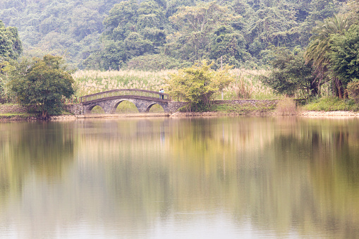 Cuc Phuong National Park, Vietnam - December 31, 2016: a bridge on a lake in national park