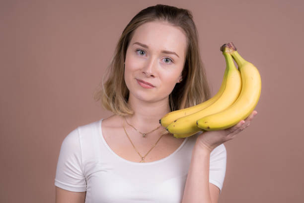 istock cute girl have fun with a banana 1132559889