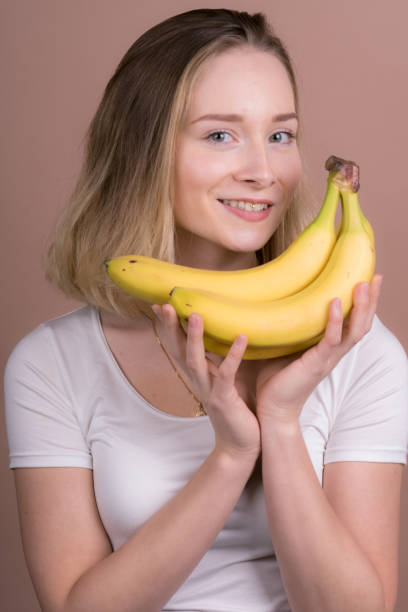 istock cute girl have fun with a banana 1132559983