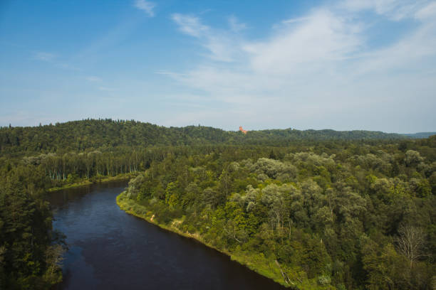View from Latvia's only cable car passing a river and forest scenery with Turaida Castle in the background (Sigulda, Latvia, Europe)