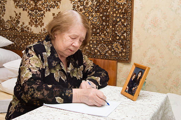 Elderly woman and  letter stock photo