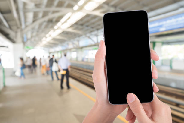 istock Cropped Hand Using Blank Phone At Railroad Station Platform 1132568613