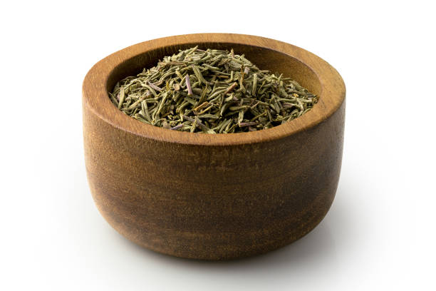 istock Dried rubbed thyme in a dark wood bowl isolated on white. 1132569163