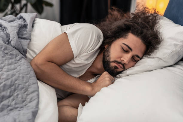 istock Pleasant handsome man lying on the pillow 1132569730
