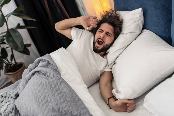 istock Pleasant good looking man trying to wake up 1132569733