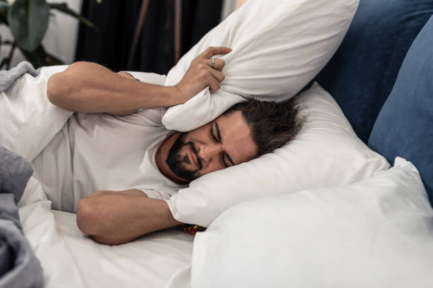 istock Unhappy sad man wanting to stay in bed longer 1132569761