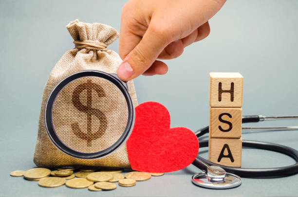 Wooden blocks with the word HSA and money bag with stethoscope. Health savings account. Health care. Health insurance. Investments. Tax-free medical expenses. Coins and dollar sign. Red heart Wooden blocks with the word HSA and money bag with stethoscope. Health savings account. Health care. Health insurance. Investments. Tax-free medical expenses. Coins and dollar sign. Red heart free syrian army stock pictures, royalty-free photos & images