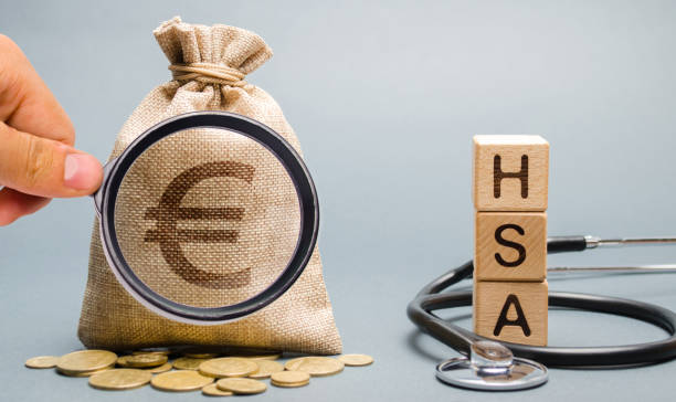 Wooden blocks with the word HSA and money bag with stethoscope. Health savings account. Health care. Health insurance. Investments. Tax-free medical expenses. Coins and euro sign Wooden blocks with the word HSA and money bag with stethoscope. Health savings account. Health care. Health insurance. Investments. Tax-free medical expenses. Coins and euro sign free syrian army stock pictures, royalty-free photos & images