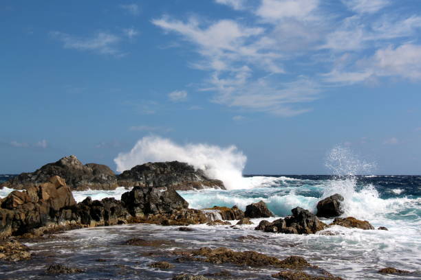 istock Waves crashing on rocks in Aruba 1132573064