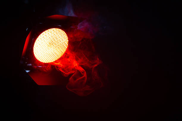 istock Red light with smoke in the dark. Equipment for photo Studio. 1132575345
