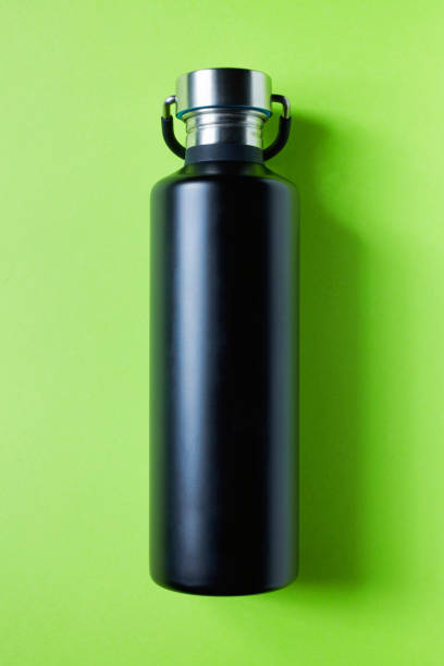 istock Black metal water bottle on green 1132575593