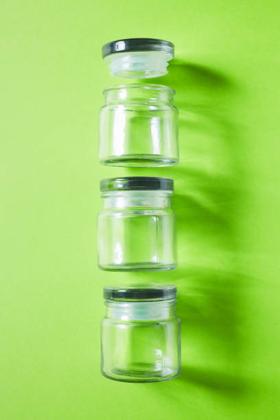 istock Glass containers on green background, from above 1132575970