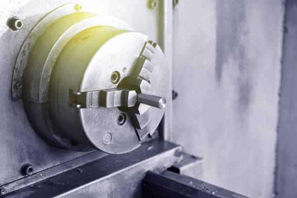 istock Spindle chuck and installed metal part on high precision Cnc industrial lathe turning machine. Close-up 1132576417