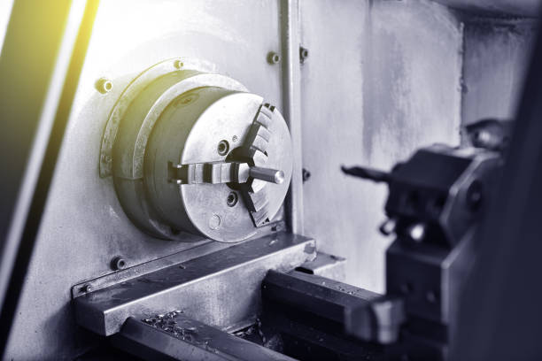 istock Spindle chuck and installed metal part on high precision Cnc industrial lathe turning machine. Close-up 1132576422