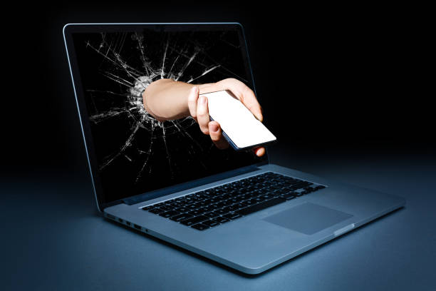 istock Hand with Smart Phone comes from laptop screen isolated on white background 1132577387