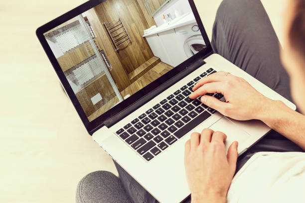 istock Handsome architect or foreman working with laptop on the apartment drawings at the structure white interior 1132577962