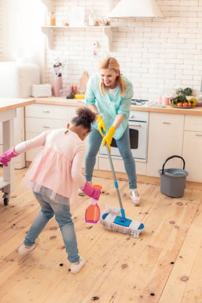 istock Mother and daughter feeling cheerful cleaning flat together 1132579515