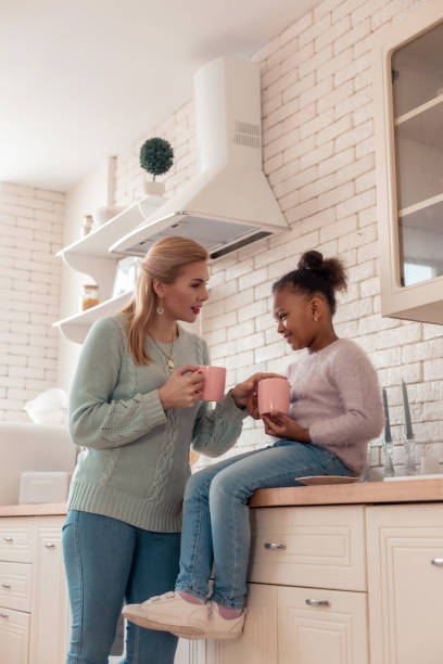 istock Blonde-haired mother drinking tea with daughter before work 1132579626