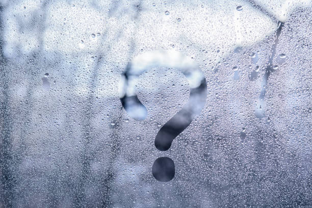 istock A print of a question mark on the wet window glass. 1132581020