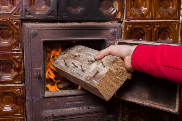 istock Throwing wood into the oven 1132581072