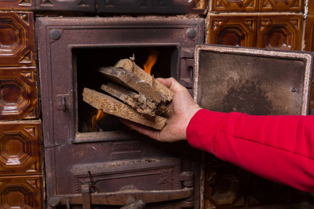 istock Throwing wood into the oven 1132581523