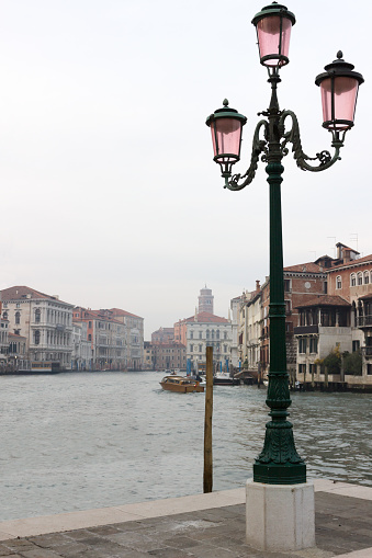 Along the iconic Grand Canal in Venice, Italy, gondolas gently sway against the backdrop of centuries-old palaces and bustling activity, creating a scene straight out of a postcard.