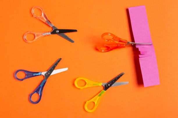 istock minimal leadership concept, four colored scissors on an orange background, scissors cut paper, business 1132584834