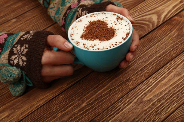 istock Cropped Hands Of Woman Holding Coffee Cup On Table 1132585160