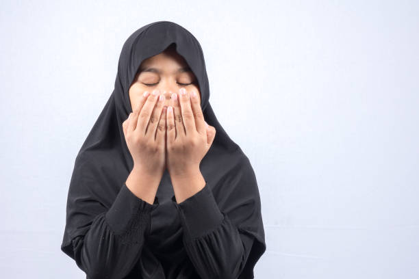 istock Girl In Hijab Praying Over White Background 1132585250