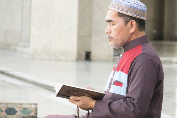 istock Mature Man Reading Koran While Sitting At Mosque 1132585776