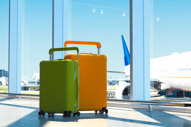 istock Two modern colored blank suitcases with airport on background, 3d rendering. 1132585990
