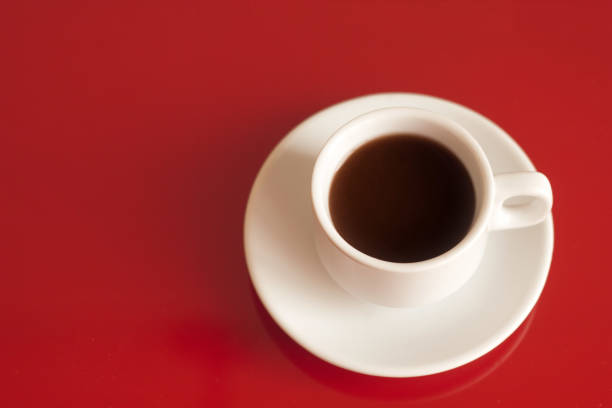 istock cup of black coffee on a red background copy space 1132588445