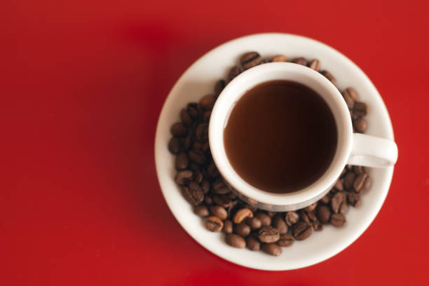 top view cup of black coffee on a red background copy space