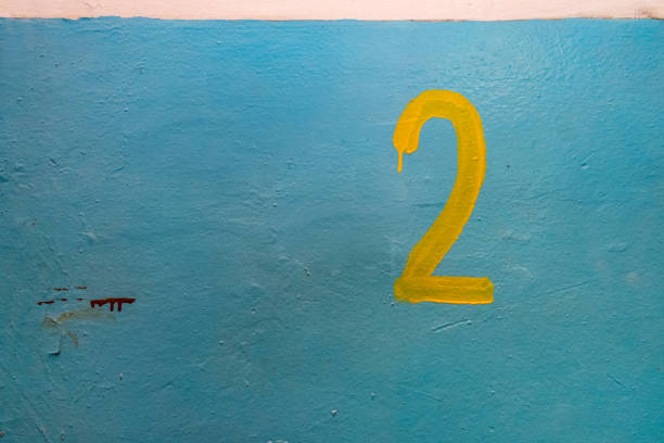 istock Yellow number two on the blue painted w 1132588609