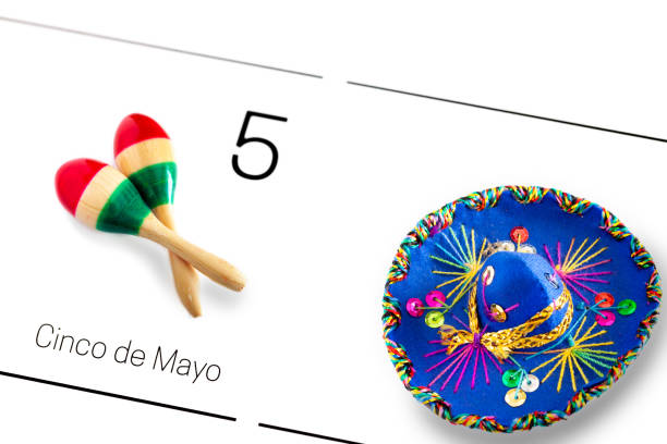 Save the date white calendar for Cinco de Mayo, May 5th with colorful sombrero and maracas painted in the colors of the Mexican Flag/ Cinco de Mayo concept stock photo