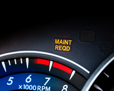 Engine maintenance or service light is on in car dashboard. Car dashboard cluster background