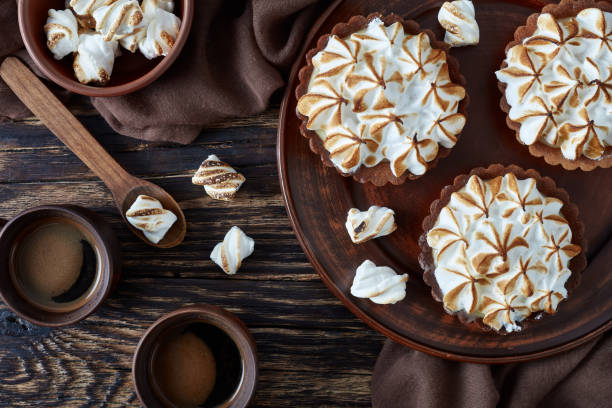 istock Lemon meringue chocolate tartlets on a table 1132590707