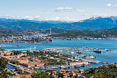 View of the military, commercial dock and ships with mountains of La Spezia in Italy