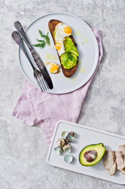 istock Avocado sandwich with egg on a gray plate. Grey background, top view. 1132598337