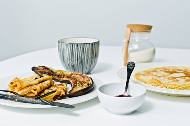 istock Traditional Russian pancakes with blueberry jam, Breakfast with coffee. White background, top view, close up. 1132598618