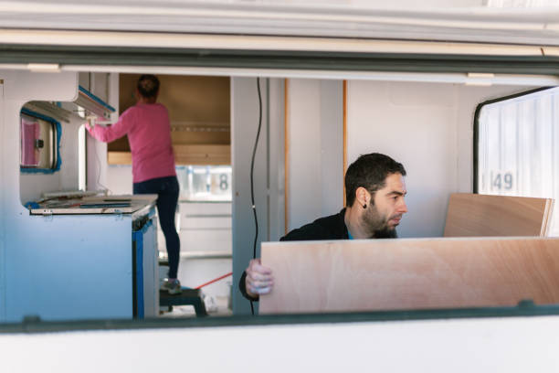 istock Young couple painting and restoring caravan 1132599210