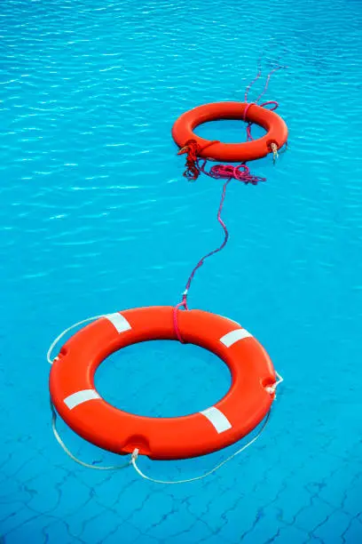Photo of Orange color life preservers floating in swimming pool in Greece