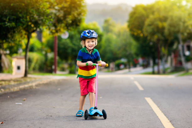 istock Child on scooter in summer. Kids skate. 1132602630